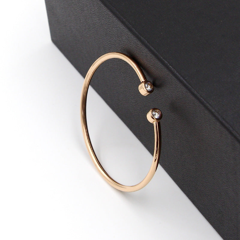 Gold-tone open bracelet with twin crystals