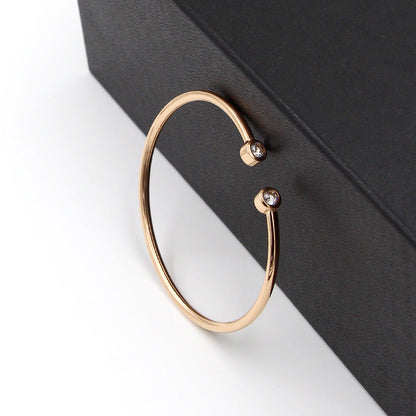 Gold-tone open bracelet with twin crystals