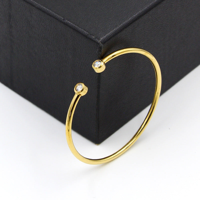 Gold-tone open bracelet with twin crystals
