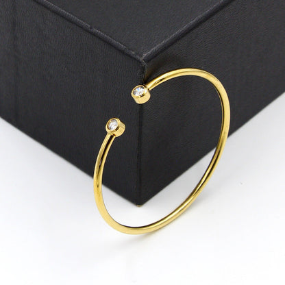 Gold-tone open bracelet with twin crystals