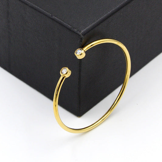 Gold-tone open bracelet with twin crystals