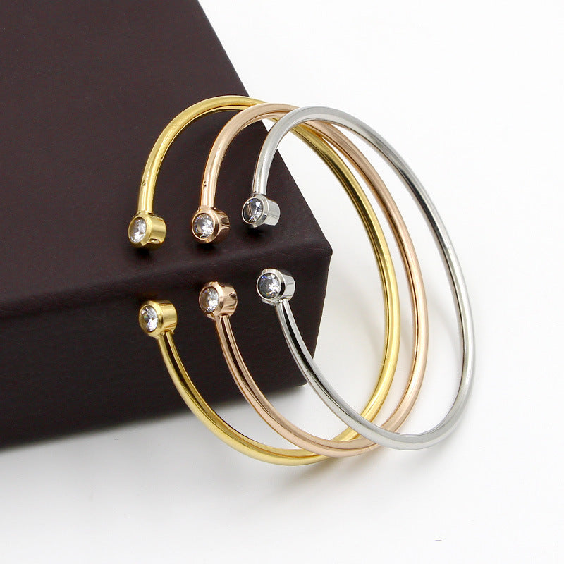 Gold-tone open bracelet with twin crystals
