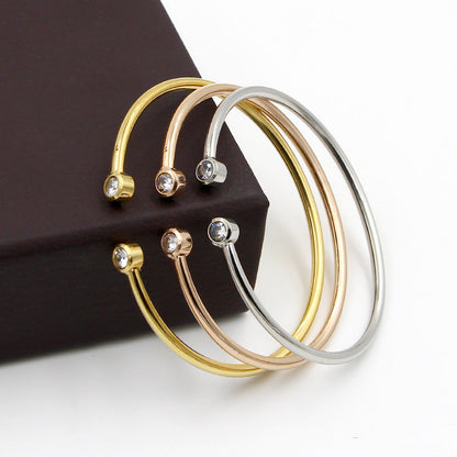 Gold-tone open bracelet with twin crystals