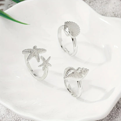 Set of 3 Gold-tone Shell, Star and Conch Rings