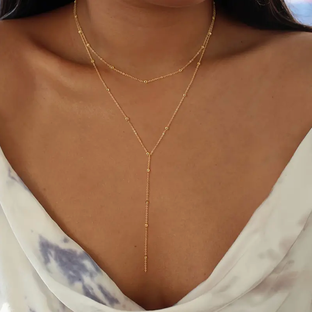 Double-layer necklace with beads and geometric tassels